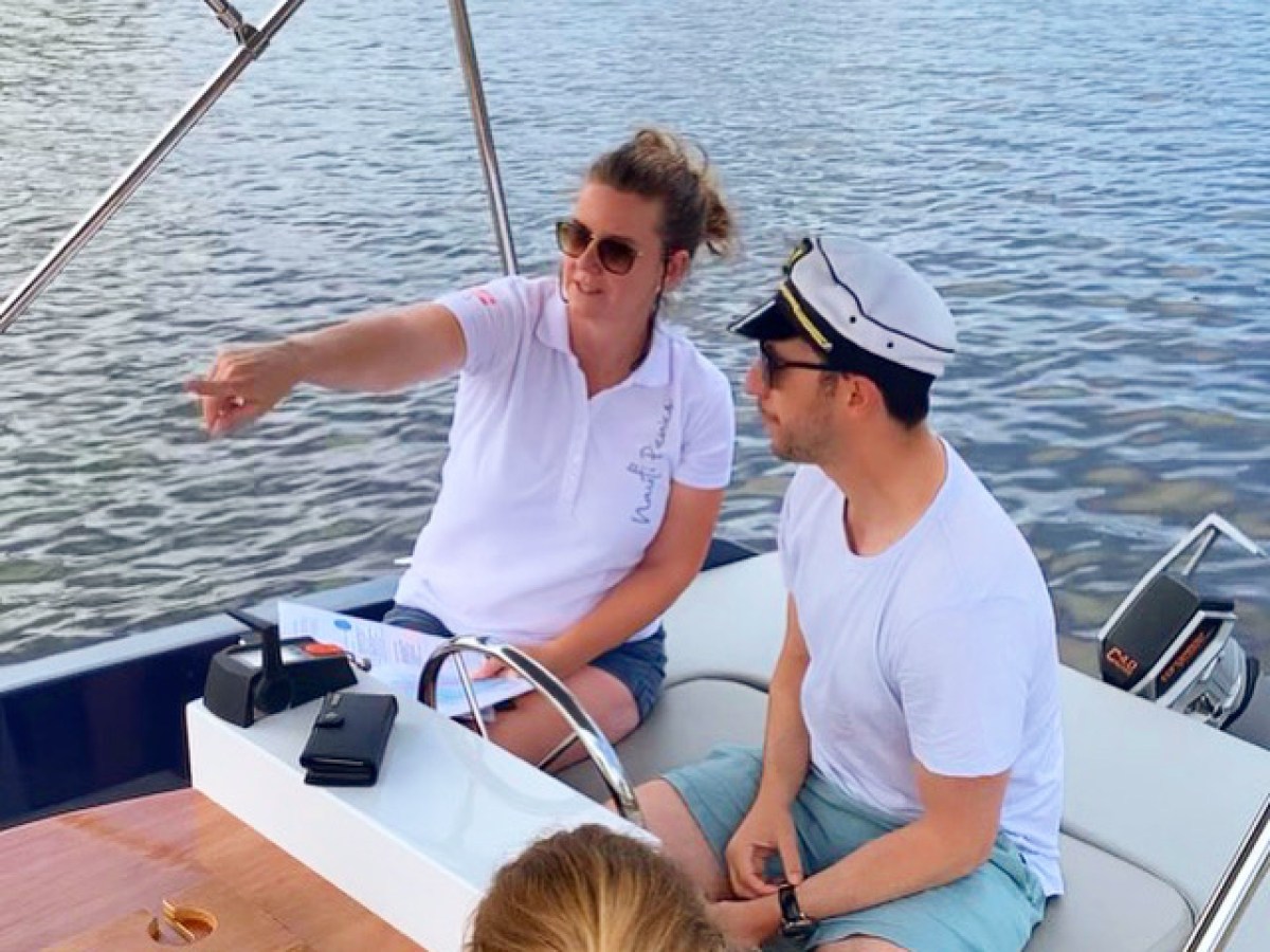 a couple of people that are sitting on a boat in the water